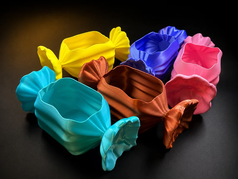 A group of printed boxes shaped like wrapped sweets in different colours