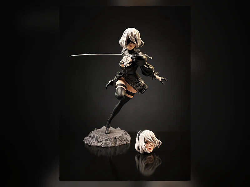 A character figure in an action pose with an extended blade on a rock base