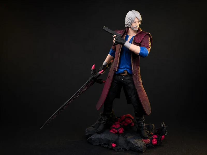 A character figure in a long coat holding a sword and a firearm on a rock base