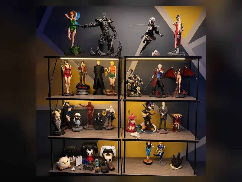 A display shelf holding several printed figures at different sizes and finishes